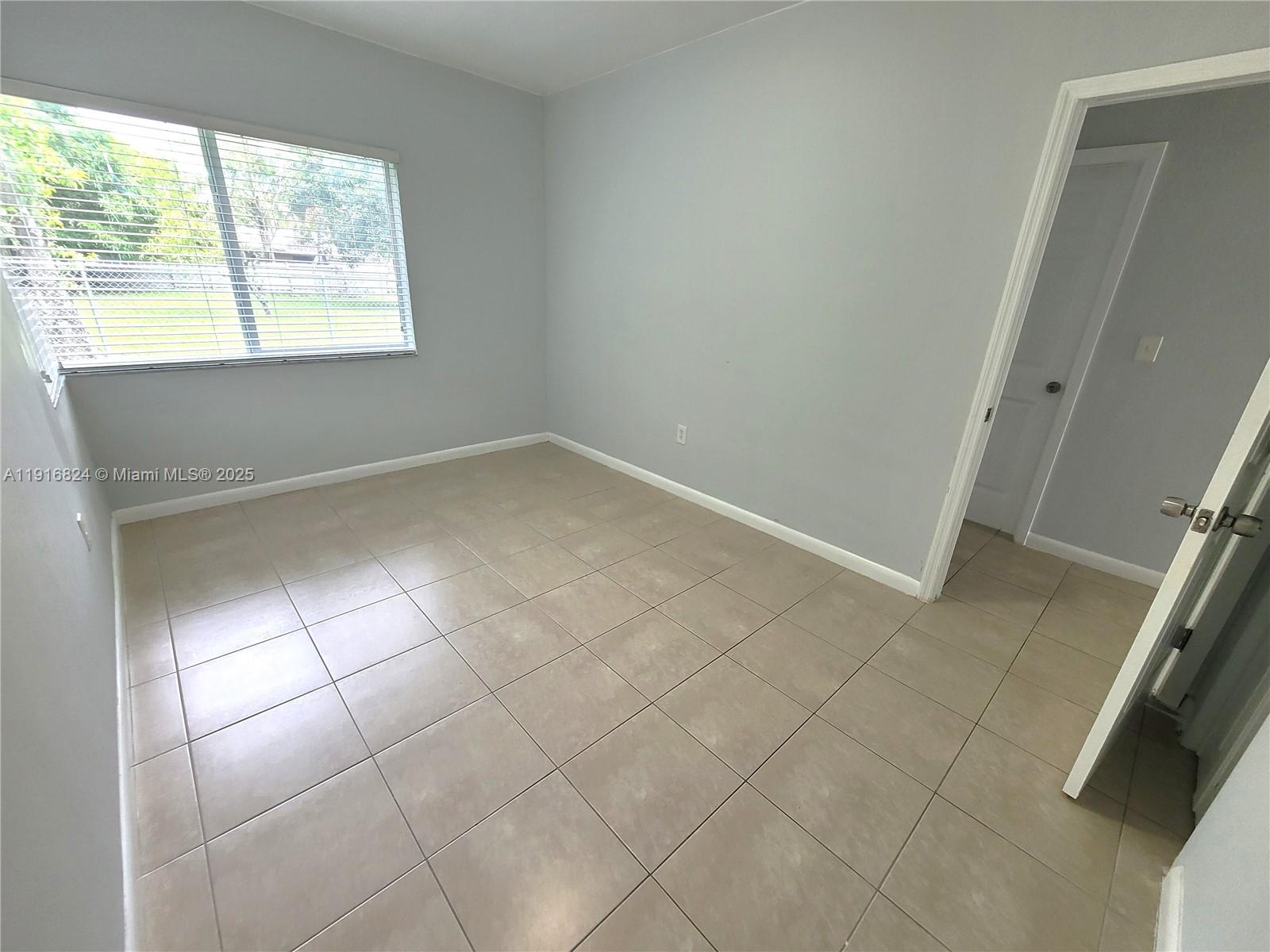8839 Southwest 28th Street Miami, FL 33165 - Photo 20 of 29 an empty room with windows