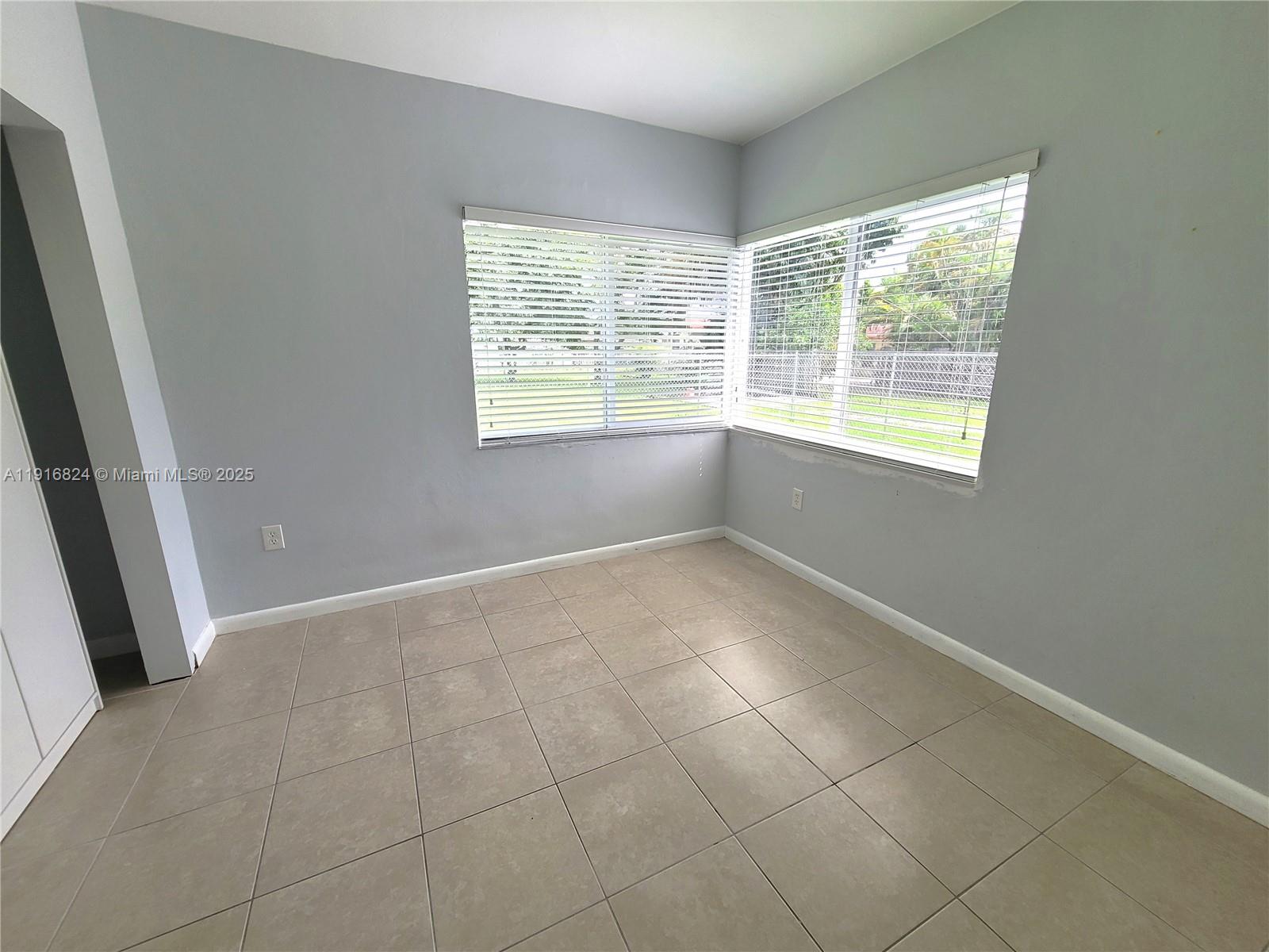 8839 Southwest 28th Street Miami, FL 33165 - Photo 21 of 29 an empty room with windows