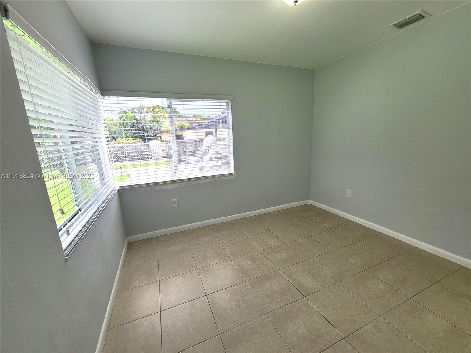8839 Southwest 28th Street Miami, FL 33165 - Photo 22 of 29 a view of an empty room with a window
