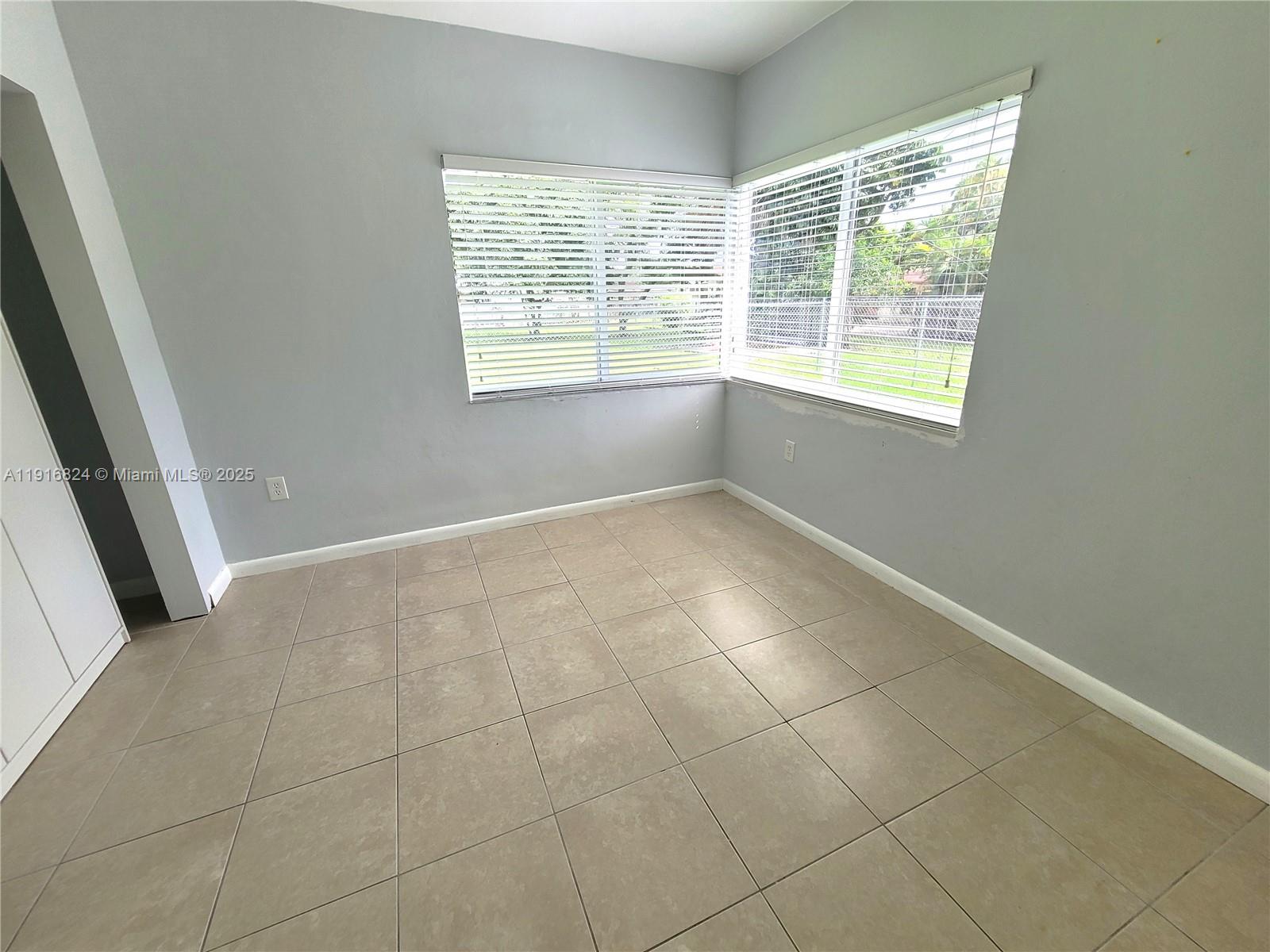 8839 Southwest 28th Street Miami, FL 33165 - Photo 23 of 29 an empty room with windows