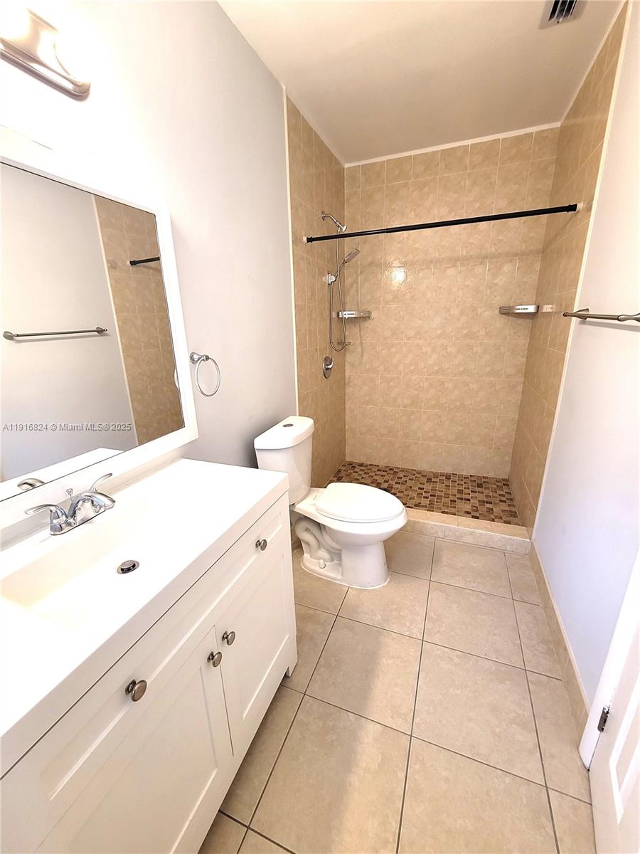 8839 Southwest 28th Street Miami, FL 33165 - Photo 24 of 29 a bathroom with a sink a toilet and a shower