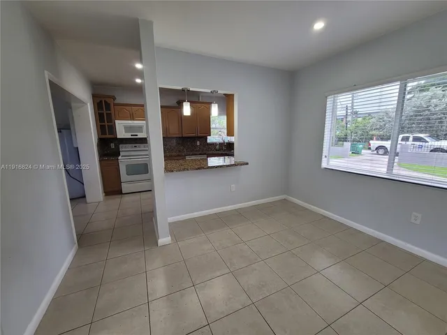 a view of a kitchen with a sink and a refrigerator
