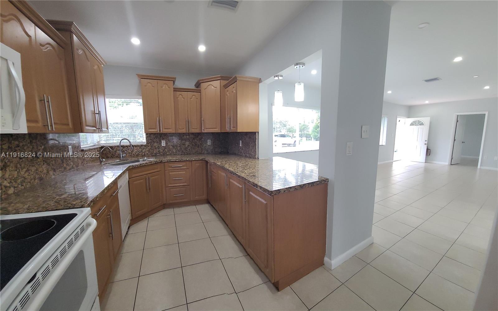 8839 Southwest 28th Street Miami, FL 33165 - Photo 7 of 29 a kitchen with a sink a counter top space stainless steel appliances and cabinets