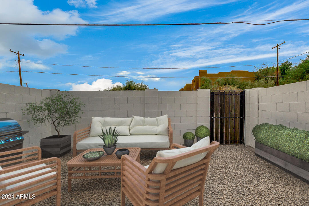 1648 West Colter Street, Unit 2 Phoenix, AZ 85015 - Photo 13 of 17 a view of a patio with couches and a potted plant