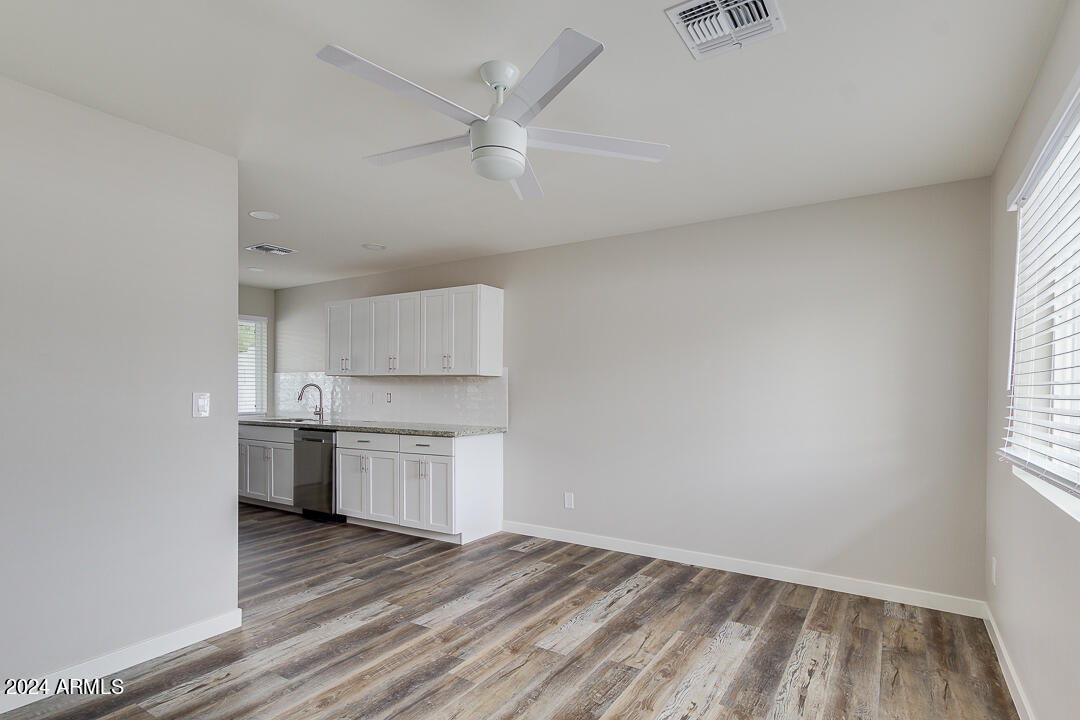 1648 West Colter Street, Unit 2 Phoenix, AZ 85015 - Photo 4 of 17 wooden floor in an empty room with a kitchen