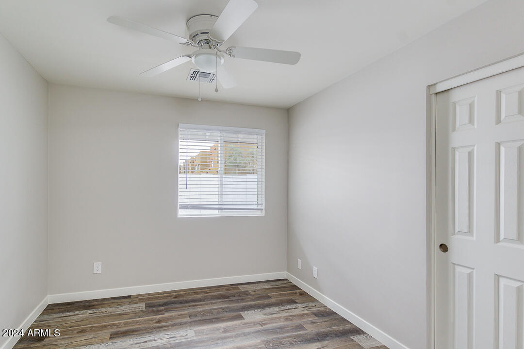 1648 West Colter Street, Unit 2 Phoenix, AZ 85015 - Photo 8 of 17 a view of room with window and hardwood floor