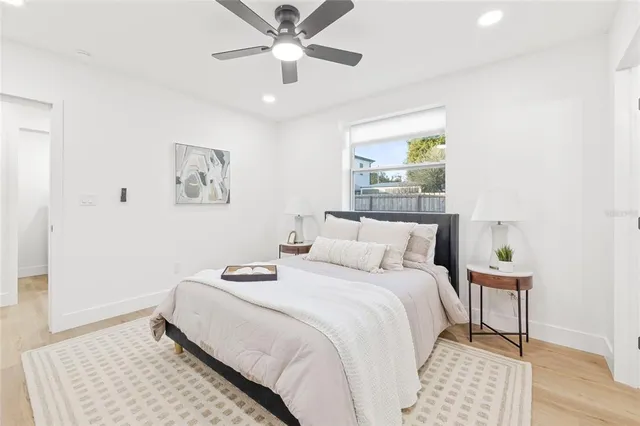 a bedroom with a bed and a painting on the wall