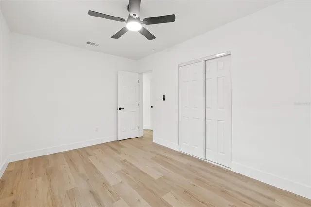a view of a big room with a big yard and large trees