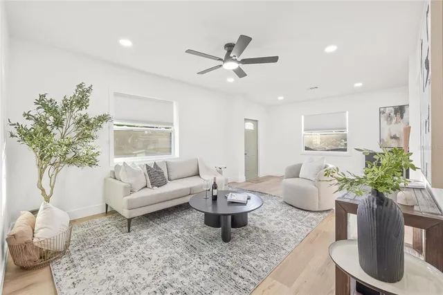 a living room with furniture potted plant and a window