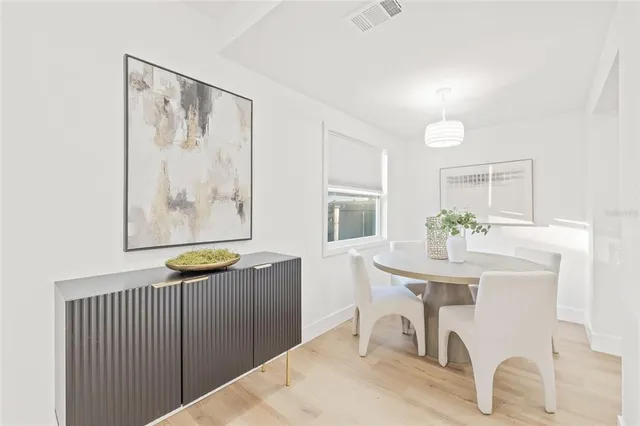 a dining room with furniture and window