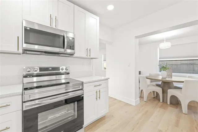 a kitchen with a stove and a microwave
