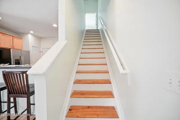 a view of entryway and hall with wooden floor