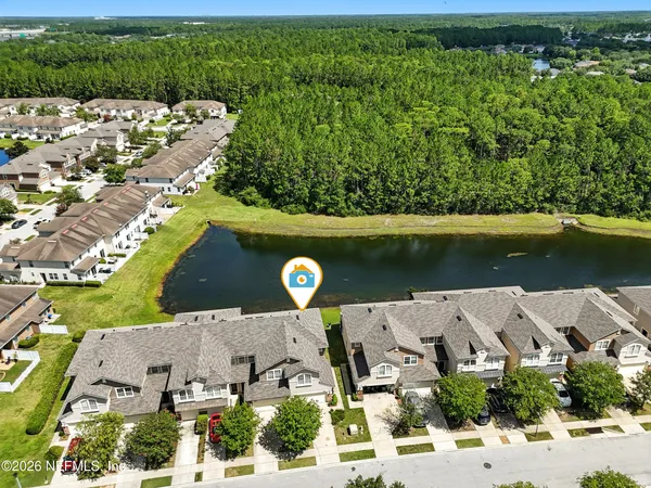 an aerial view of a house with a yard