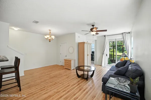a living room with furniture and a chandelier