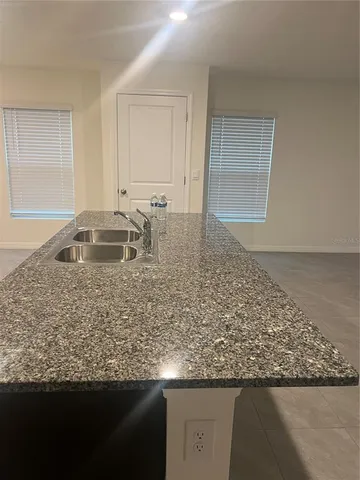 a view of wooden floor and kitchen island