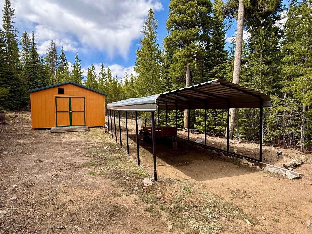 10000 Forest Road, Unit 169 Red Feather Lakes, CO 80545 - Photo 24 of 31 Sturdy covered carport and outbuilding across from the Main Cabin.