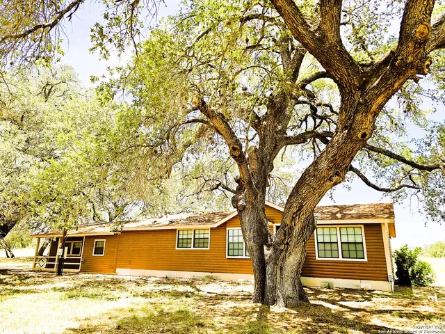 a kitchen with stainless steel appliances granite countertop a refrigerator a stove top oven and a sink