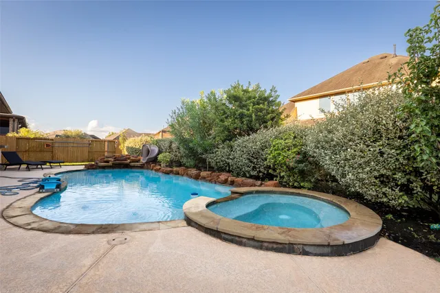 a view of a swimming pool with a yard