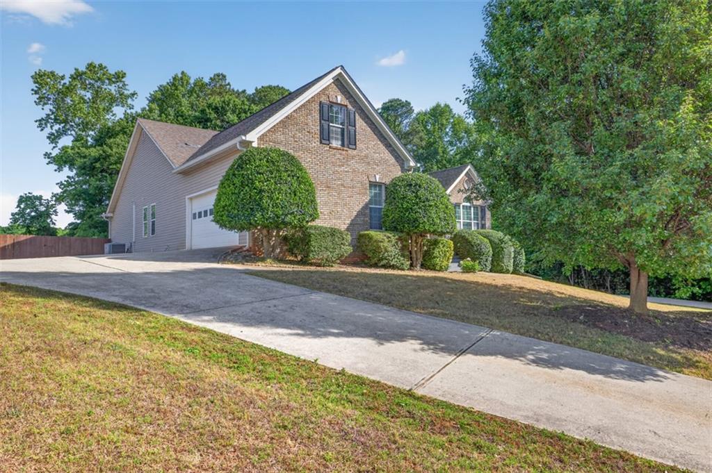89 Katie Spring Lane Jefferson, GA 30549 - Photo 7 of 63 a front view of a house with a yard and garage