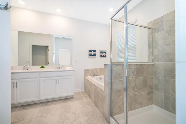a spacious bathroom with a shower a sink and a mirror