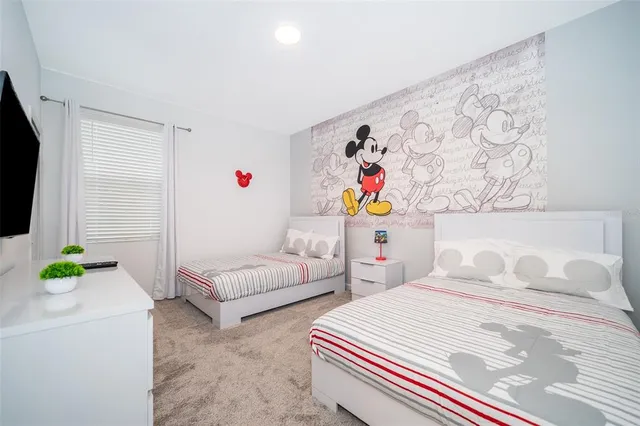 a bedroom with two beds and a couch