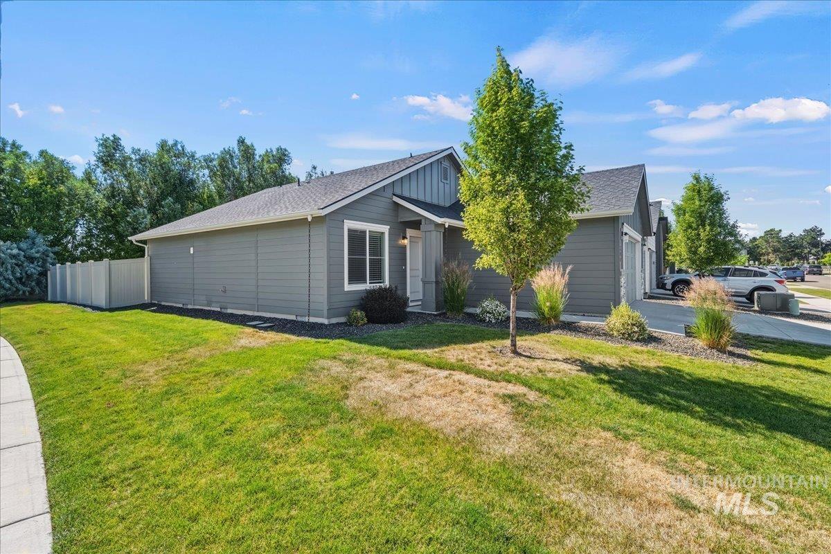 3091 S Green Boise, ID 83709 - Photo 5 of 27 Contemporary exterior with gray siding, white trim, and a dark shingle roof