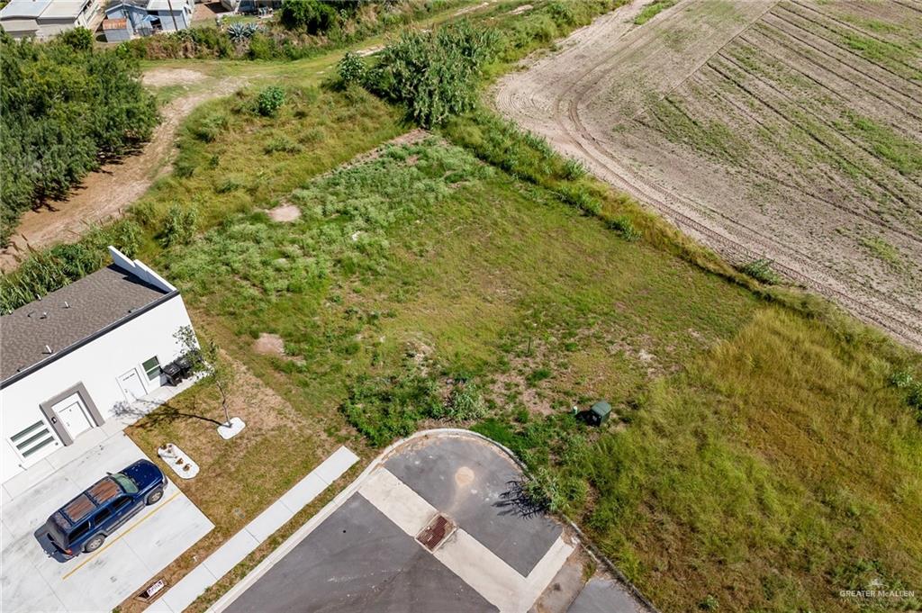 Lot 11 Larkview Street Weslaco, TX 78596 - Photo 5 of 6 an aerial view of a house with a yard and trees
