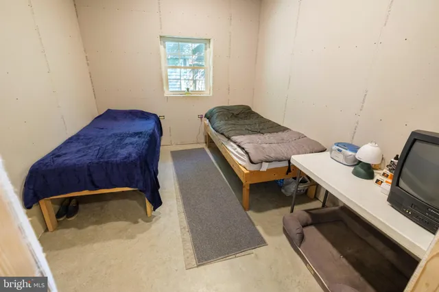 a bedroom with a bed and a mirror