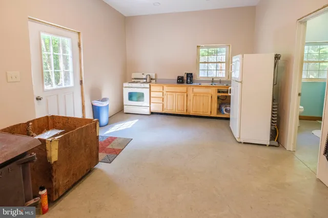 a kitchen with a stove top oven and a refrigerator