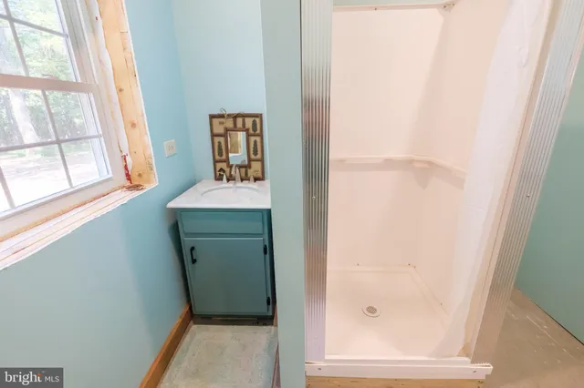 a view of walk in closet with clothes