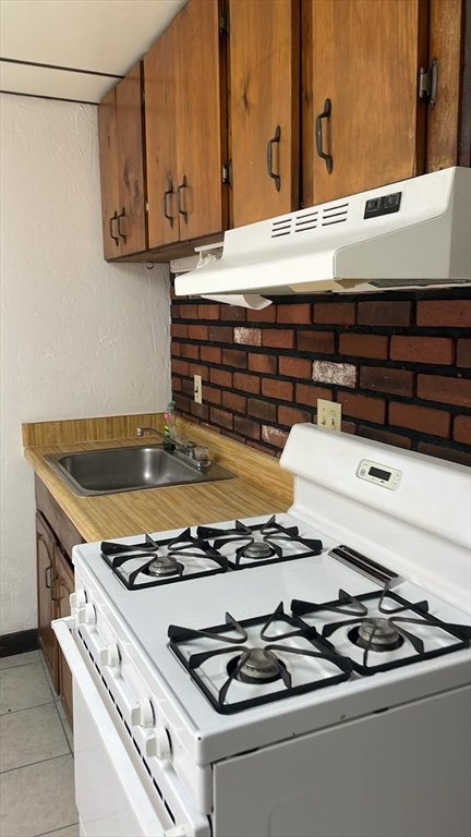 230 Pearl Street, Unit 1 Somerville, MA 02145 - Photo 2 of 11 a stove top oven sitting inside of a kitchen