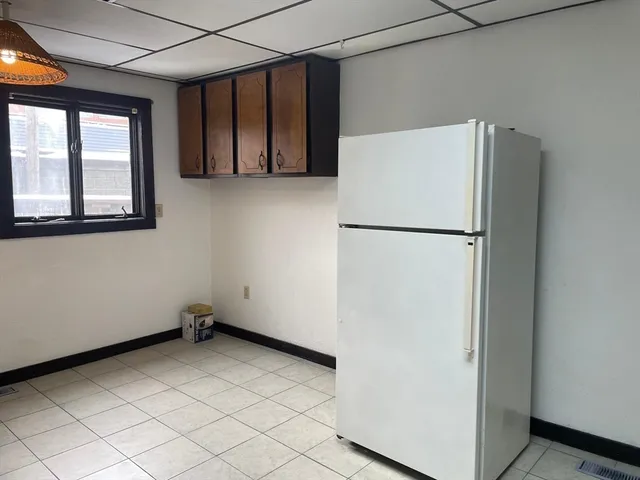 a view of a refrigerator in kitchen and furniture