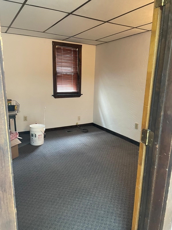 230 Pearl Street, Unit 1 Somerville, MA 02145 - Photo 7 of 11 a view of a room with wooden floor and windows