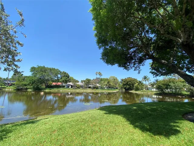 a view of a lake with houses in the back