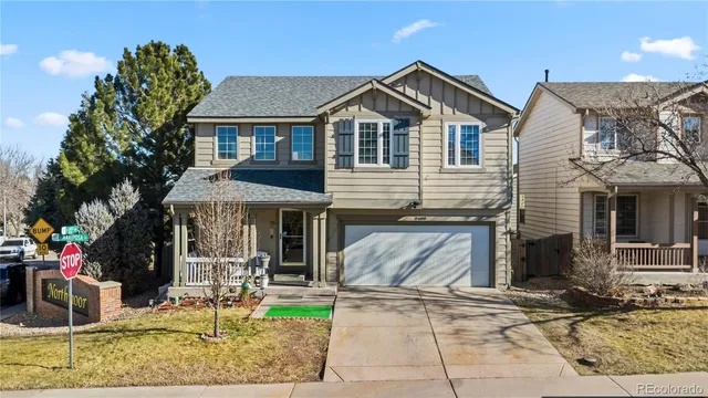 an aerial view of a residential houses with city view