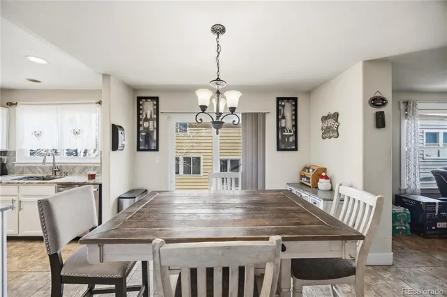 a living room with furniture ceiling fan and a flat screen tv