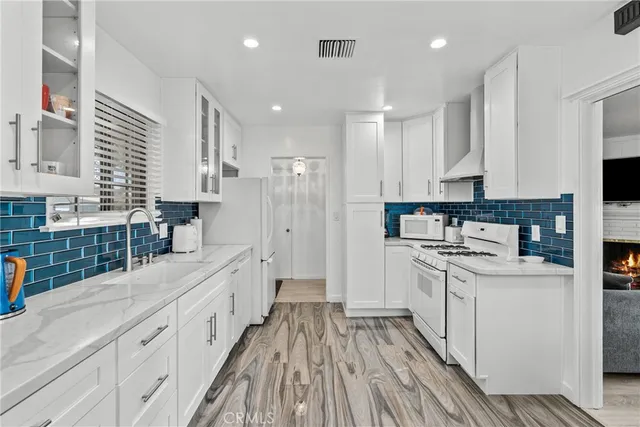 a kitchen with stainless steel appliances sink refrigerator and microwave
