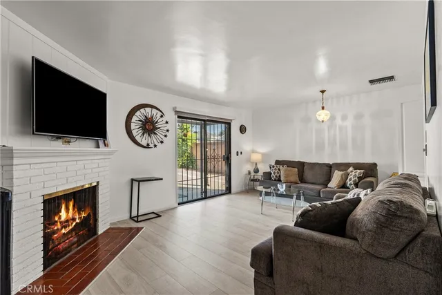 a living room with furniture a clock and a flat screen tv