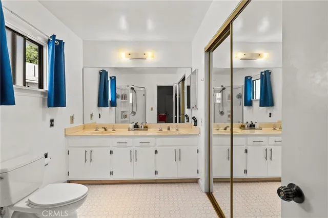 a bathroom with a double vanity sink and a mirror