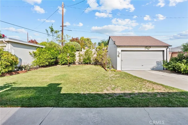 a view of a backyard with plants and lake view