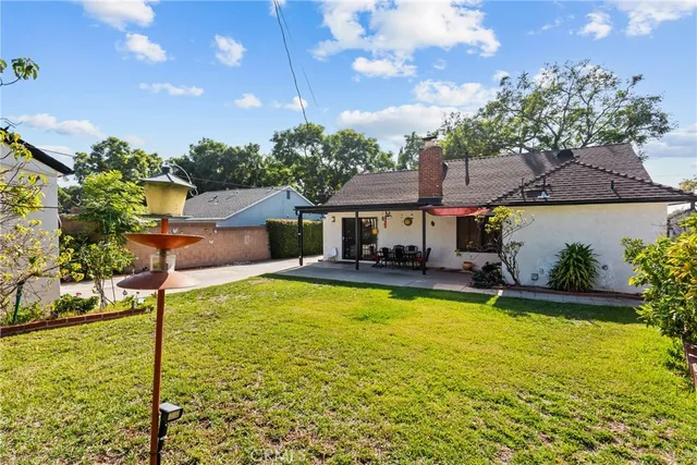 a front view of house with yard and outdoor seating
