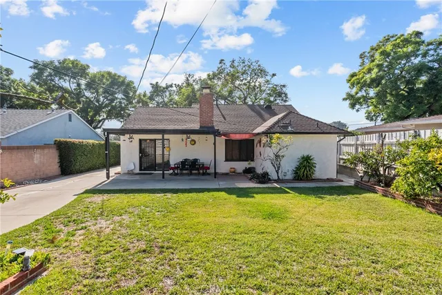 a view of a house with swimming pool and a yard