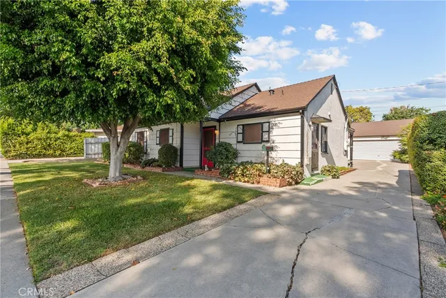 a front view of house with yard and green space