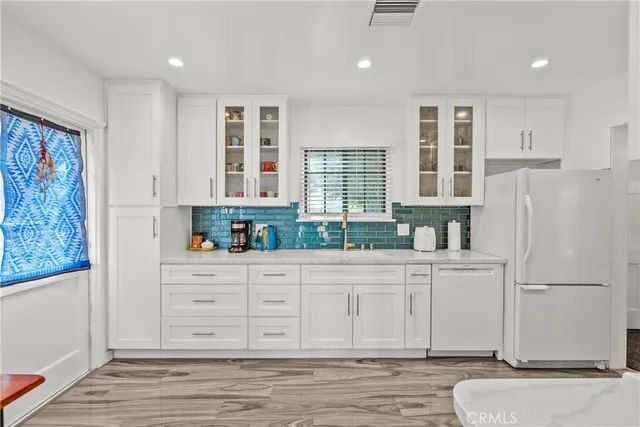 a kitchen with stainless steel appliances granite countertop a refrigerator sink and cabinets