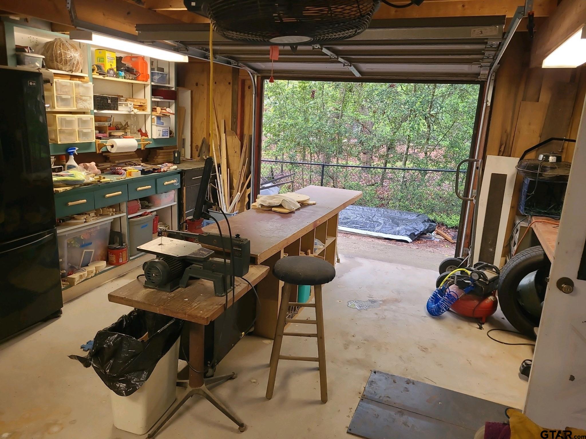 201 Elmwood Lane Holly Lake Ranch, TX 75765 - Photo 22 of 34 a view of a workspace with furniture and a window