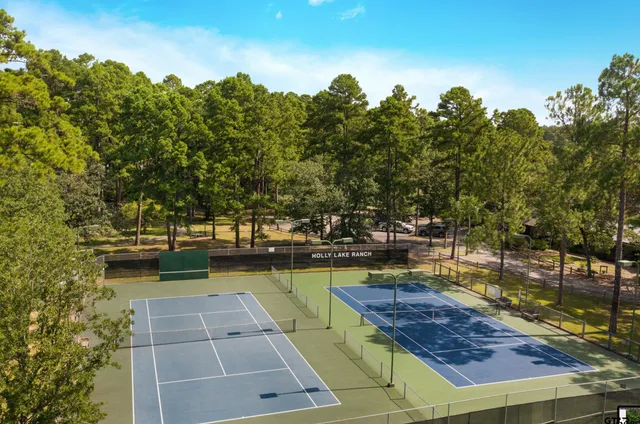 a view of a swimming pool with a patio and a yard