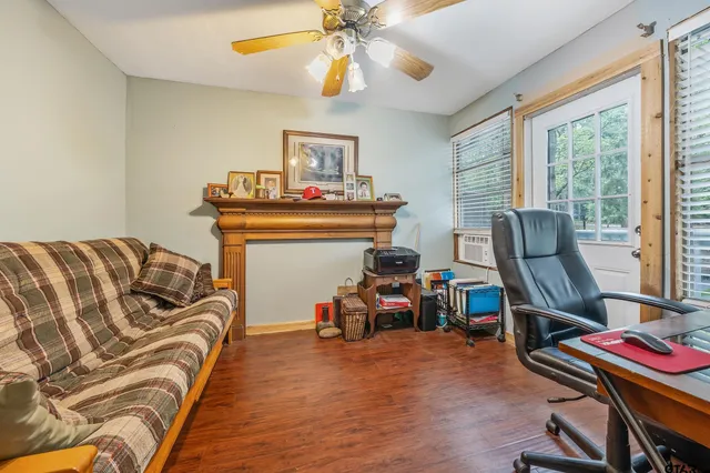 a bedroom with furniture and a wooden floor