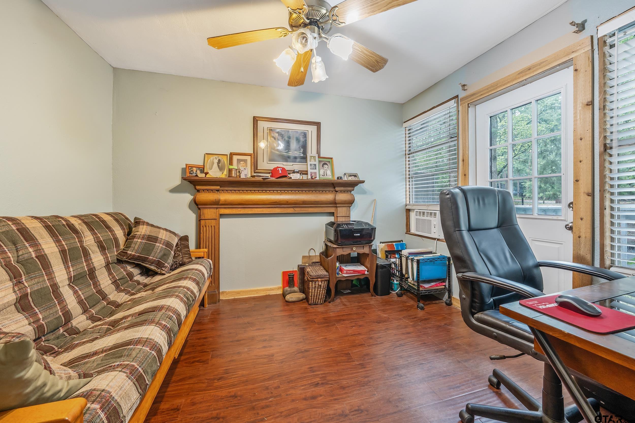 201 Elmwood Lane Holly Lake Ranch, TX 75765 - Photo 5 of 34 a bedroom with furniture and a wooden floor
