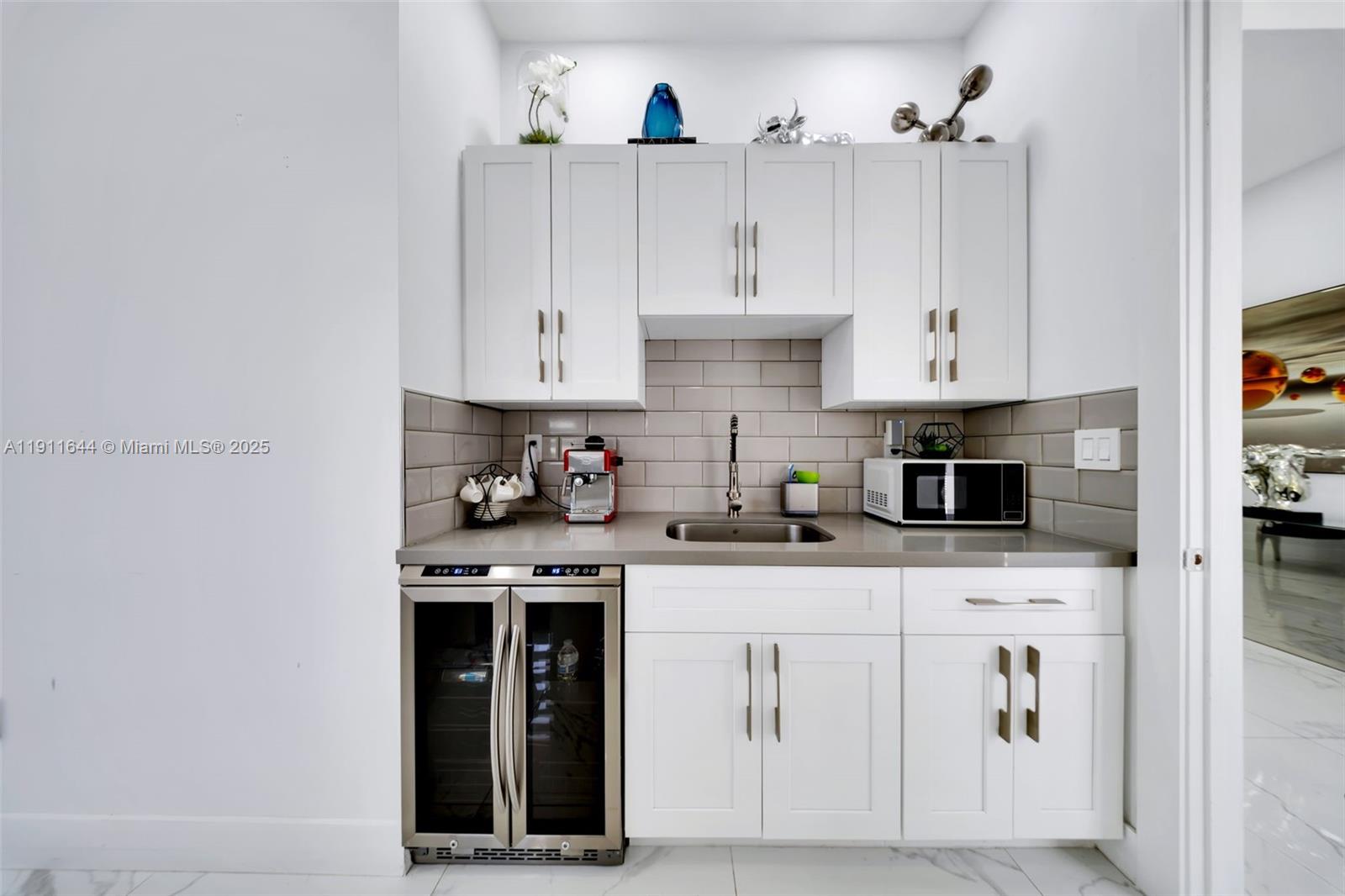 1550 Southwest 89th Court Miami, FL 33174 - Photo 14 of 67 a kitchen with white cabinets and sink