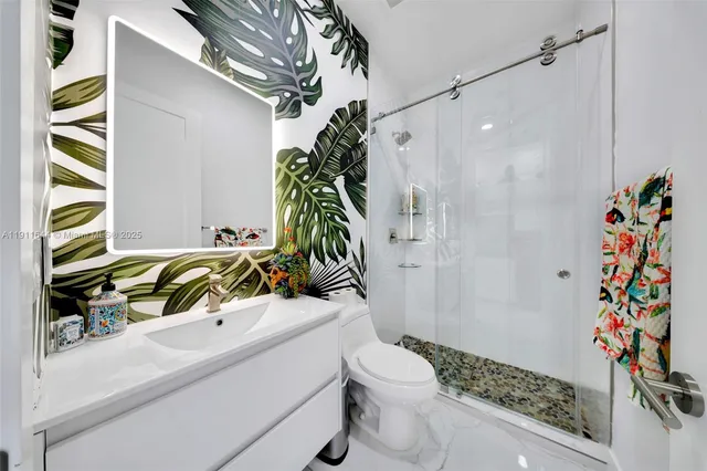 a kitchen with stainless steel appliances granite countertop a sink refrigerator and microwave